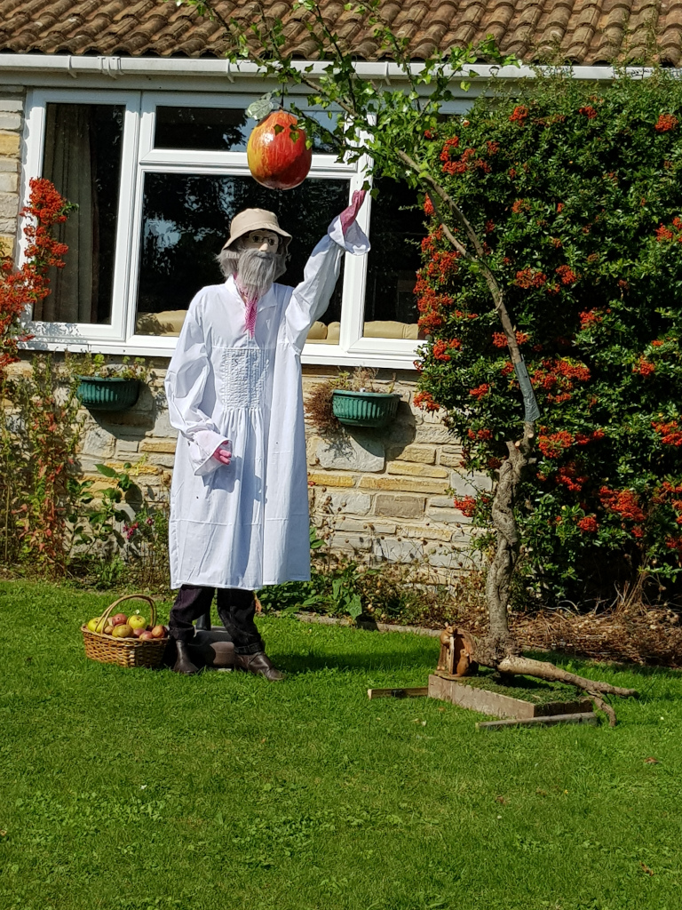 scarecrow picking a large apple